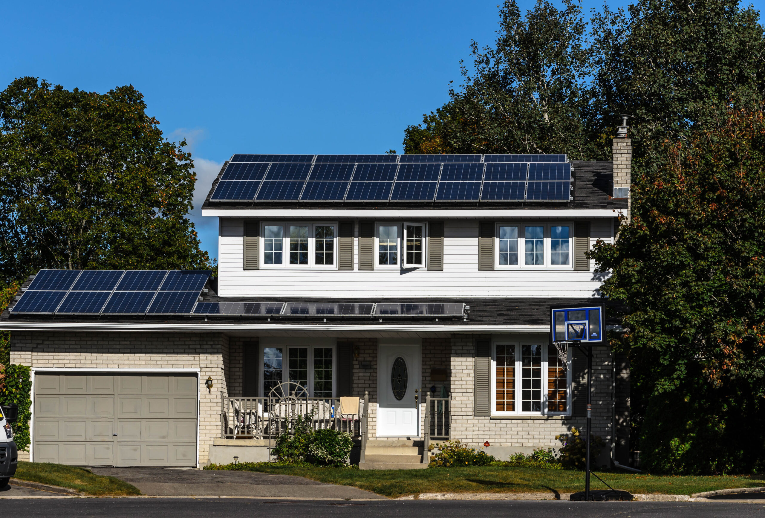 Solar,Panels,On,A,Suburban,House,Rooftop,With,Trees,And